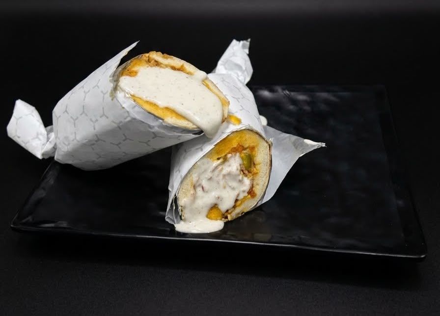 Chicken Shawarma, signature dish at Cock "N" Bull. Marinated chicken with our signature garlic sauce, fresh veg, pickles. Hand-rolled to order. A late-night clas… Pakistani restaurant in Al Majarra, Sharjah, UAE