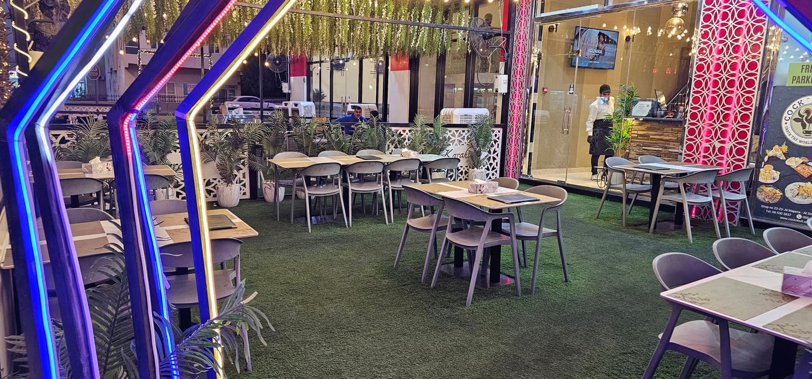 تراس خارجي في كوك أن بول الشارقة بإضاءة معلقة دافئة ونباتات - عشاء متأخر حتى الساعة 2 صباحًا
